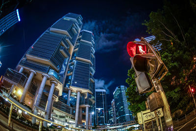 Low angle view of illuminated buildings against sky at night