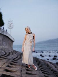 Young woman standing at beach