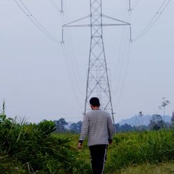 Rear view of woman standing on field