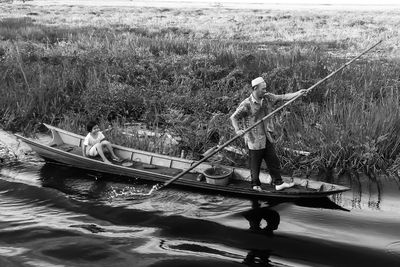 Man and woman fishing in boat