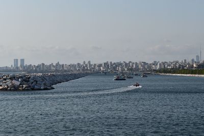 Scenic view of sea and buildings against sky