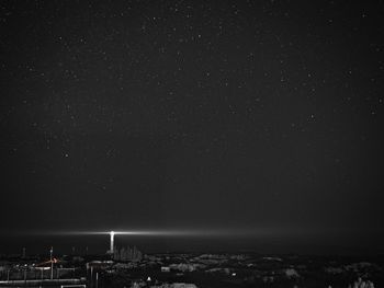 Aerial view of illuminated building against sky at night