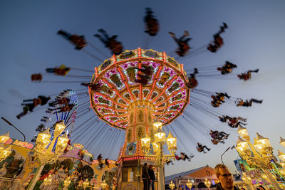 Low angle view of illuminated ferris wheel at night