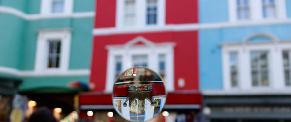 Close-up of reflection of building in city