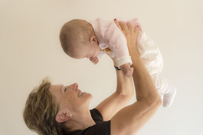 Grandmother holding to her granddaughter