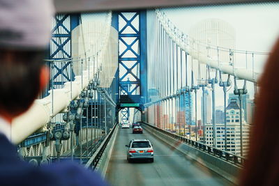 Cars moving on suspension bridge in city