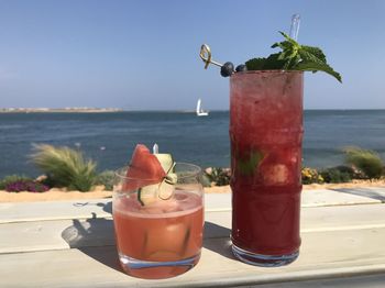 Close-up of drink on table at beach