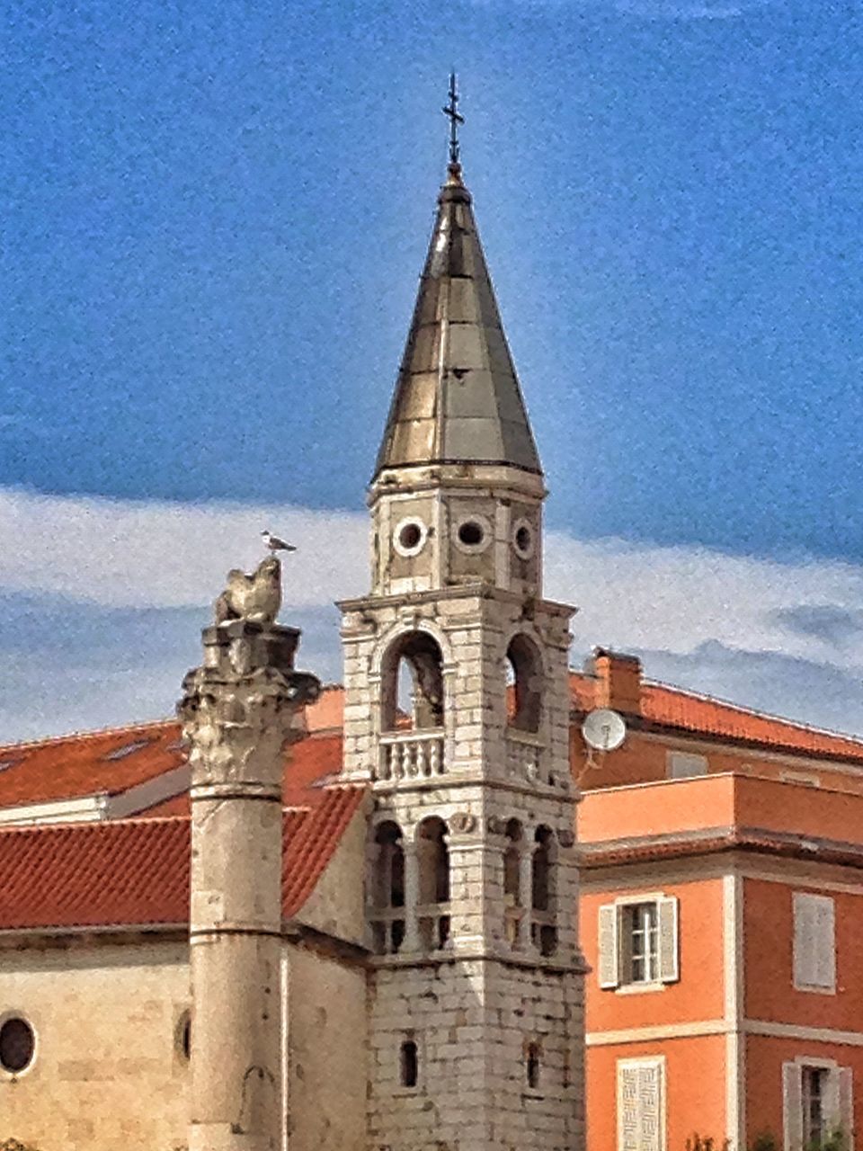 architecture, building exterior, built structure, religion, church, place of worship, spirituality, low angle view, sky, cathedral, cross, blue, day, outdoors, tower, no people, high section, cloud