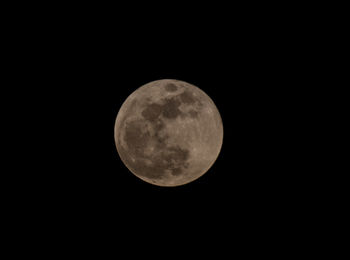 Low angle view of full moon against sky at night