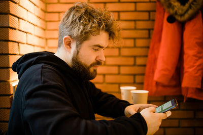 Side view of man using mobile phone