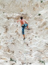 Full length rear view of man standing on rock