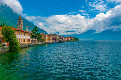 Scenic view of sea by buildings against sky