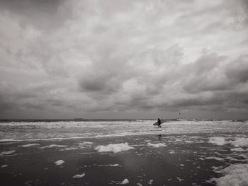 Scenic view of sea against cloudy sky