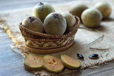 Close-up of apples in basket on table