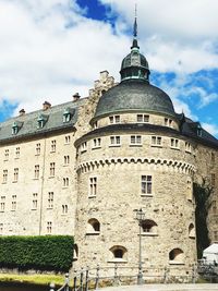 Low angle view of historical building against cloudy sky