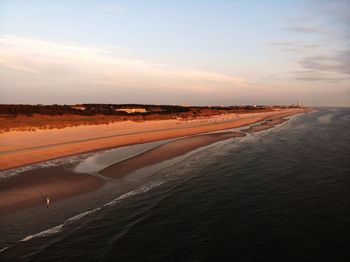 Scenic view of beach against sky during sunset