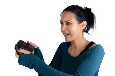 Portrait of young woman smiling against white background