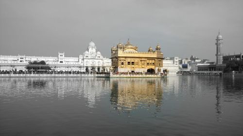 View of river by city against sky
