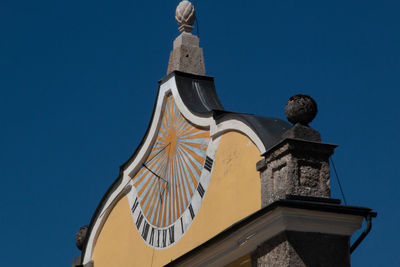 Low angle view of traditional building against clear blue sky