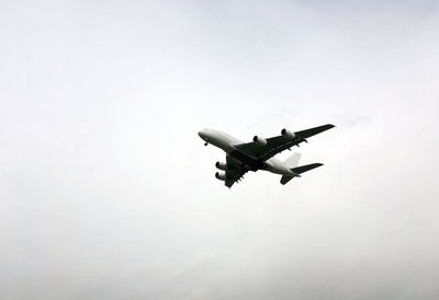 Low angle view of airplane against clear sky