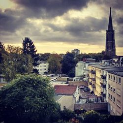 Buildings against cloudy sky