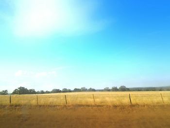 Scenic view of field against cloudy sky