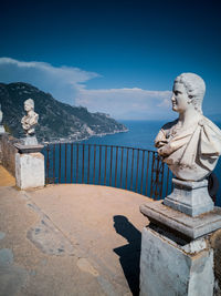 Statue of buddha against mountain and sky