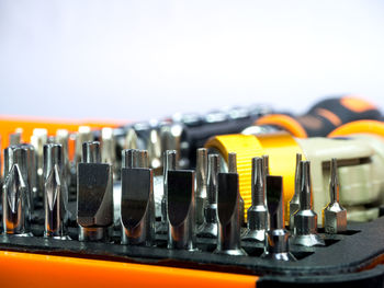 Close-up of drill bits against white background