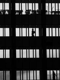 Silhouette of man working on building