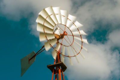 Low angle view of traditional windmill against sky