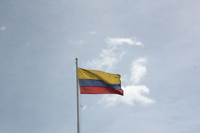 Low angle view of flags flag against sky