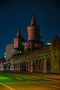 Illuminated building against clear sky at night