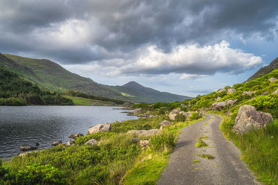 Winding country road leading trough black valley, macgillycuddys reeks mountains, ireland
