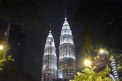 Low angle view of illuminated buildings against sky at night