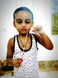 Portrait of boy holding camera