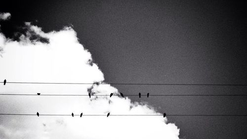 Low angle view of power lines against sky