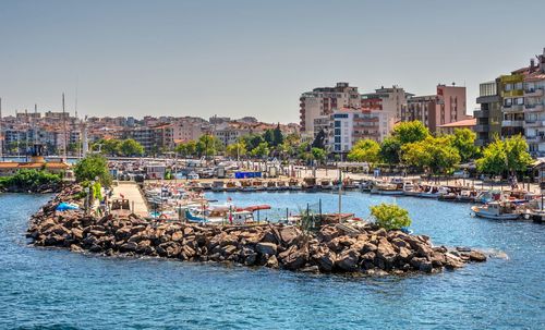 Scenic view of sea against buildings in city