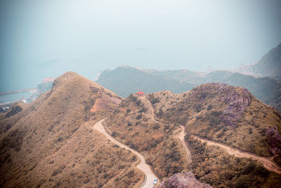 High angle view of road amidst mountains against sky