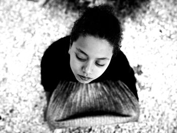 High angle view of woman sitting outdoors