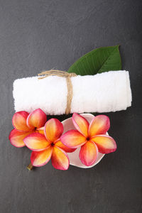 High angle view of flowers with napkin on black background