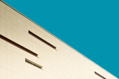 Low angle view of building against clear blue sky