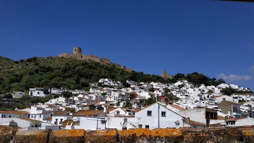 Townscape against clear blue sky