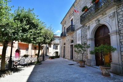 A narrow street among the old houses of greci, a village in the campania region, italy.