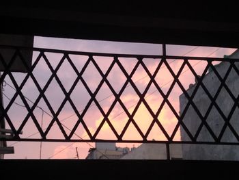 Low angle view of glass window against sky