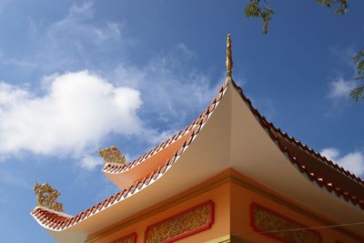 Low angle view of temple and building against sky