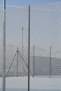 Close-up of chainlink fence against sky