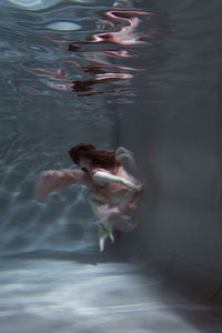 High angle view of woman swimming in pool