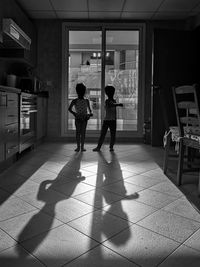 Rear view of people standing on tiled floor