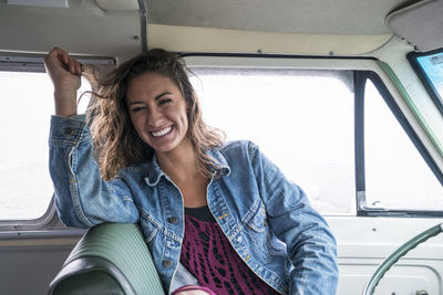 Laughing teenage girl in front seat of vintage van