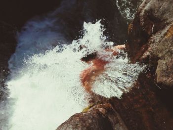 High angle view of person flowing with waterfall